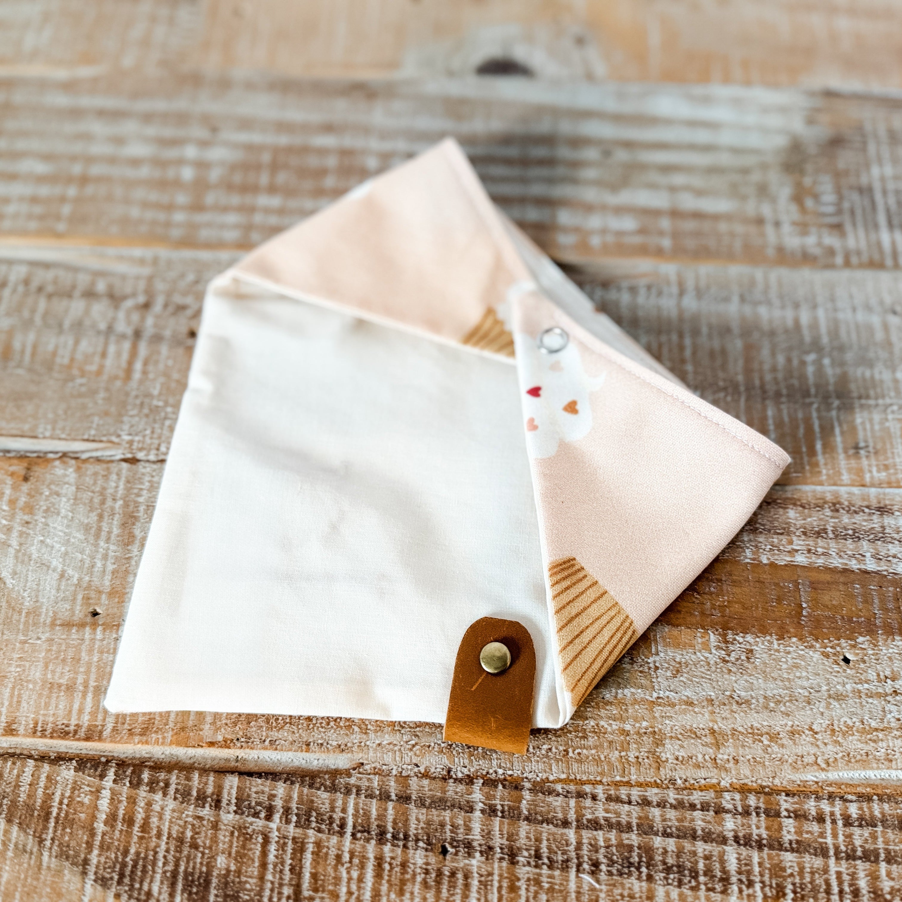 Fabric pouch with wooden handle on a rustic wooden surface