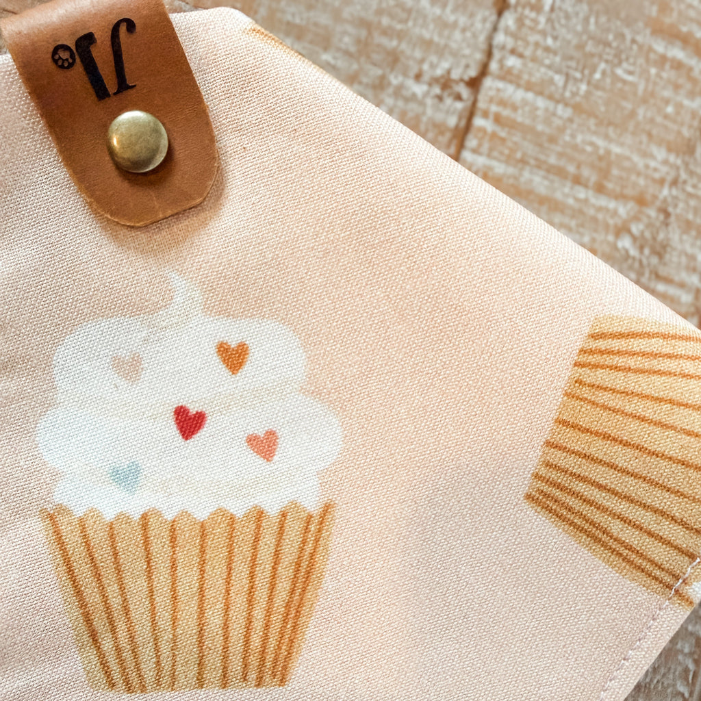 Fabric patch with a cupcake design on a beige background