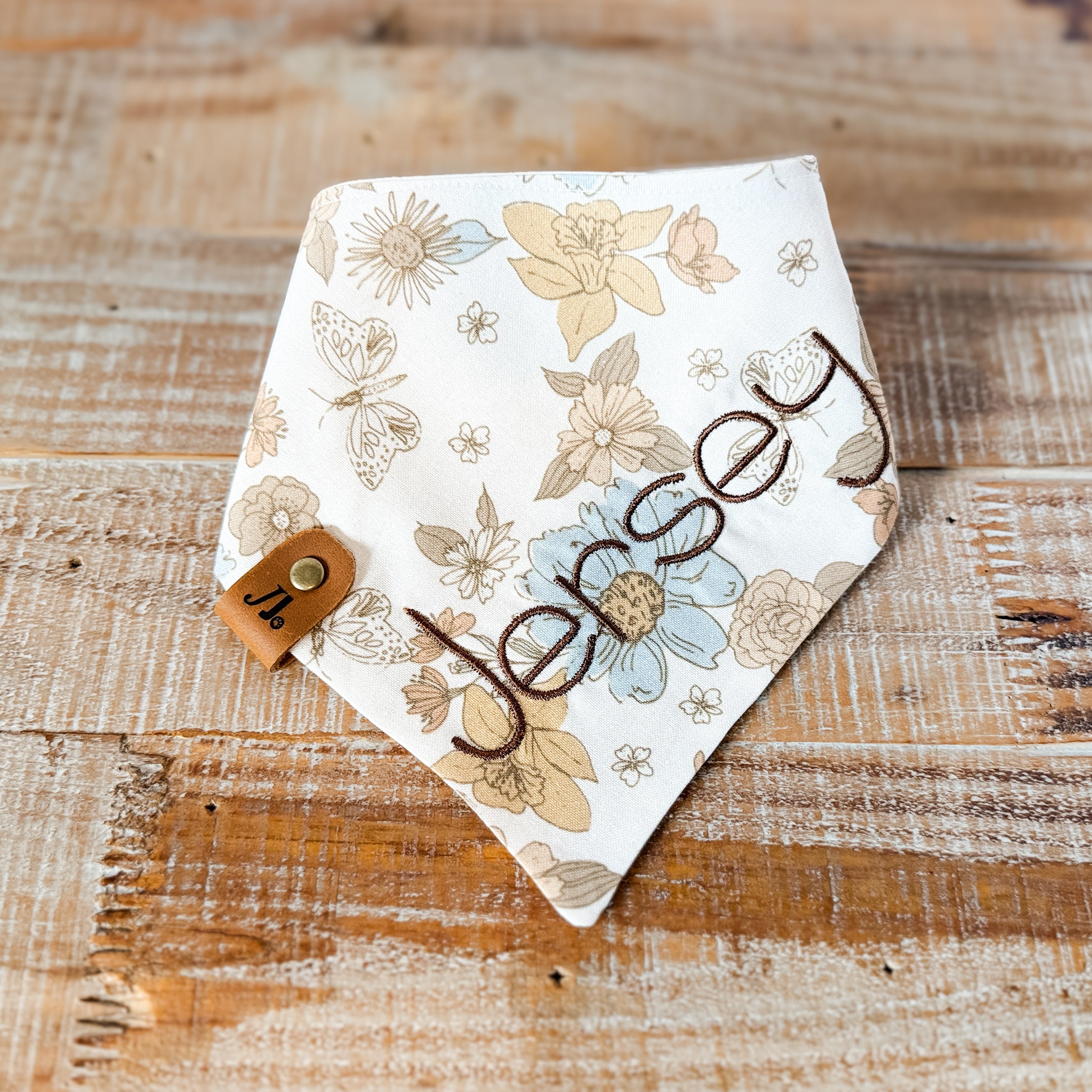 Floral patterned bandana with 'Uncle' text on a wooden surface