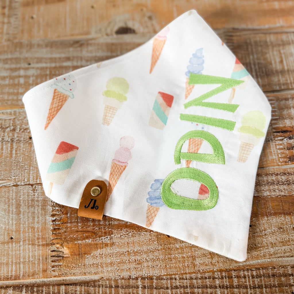 Pet Bandana with colorful letters on a wooden surface