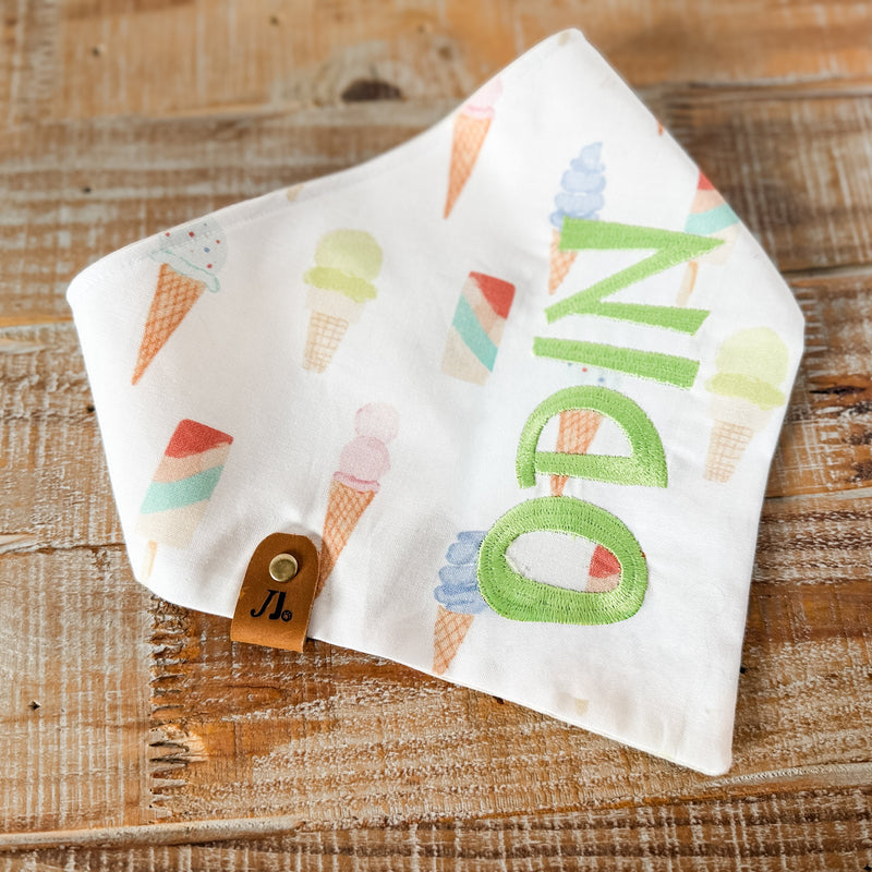 Pet Bandana with colorful letters on a wooden surface
