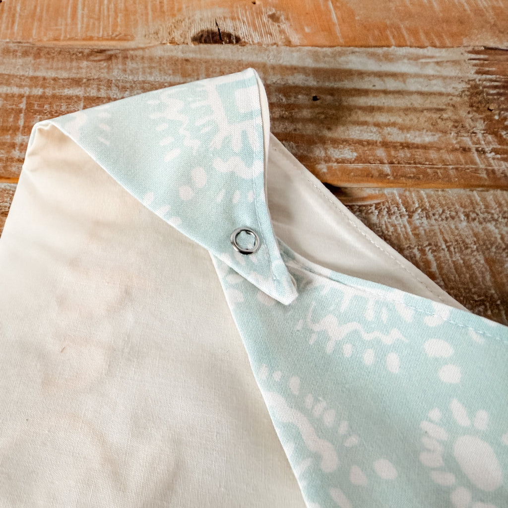 Fabric with a light blue pattern on a wooden surface