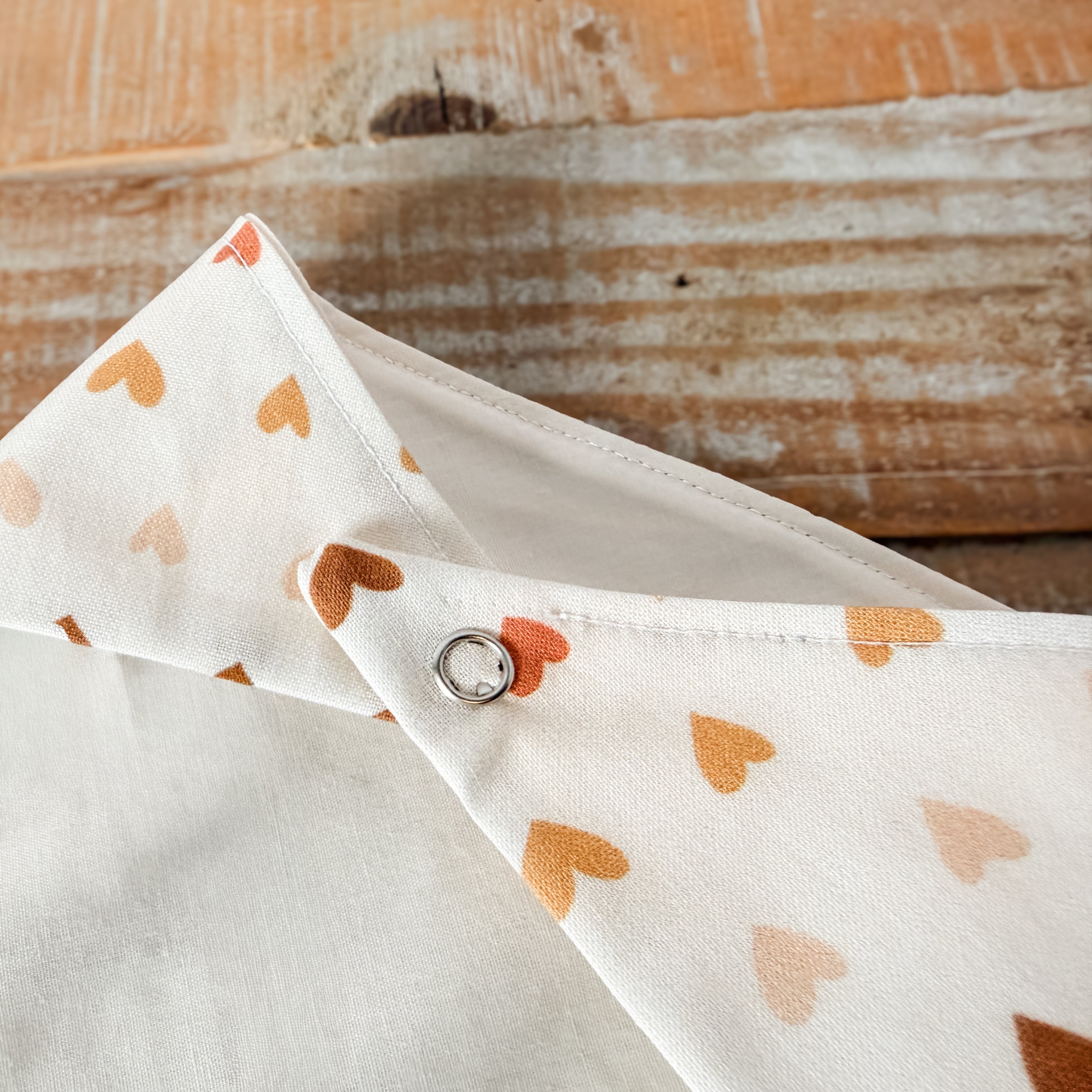 Fabric with heart pattern on a wooden surface