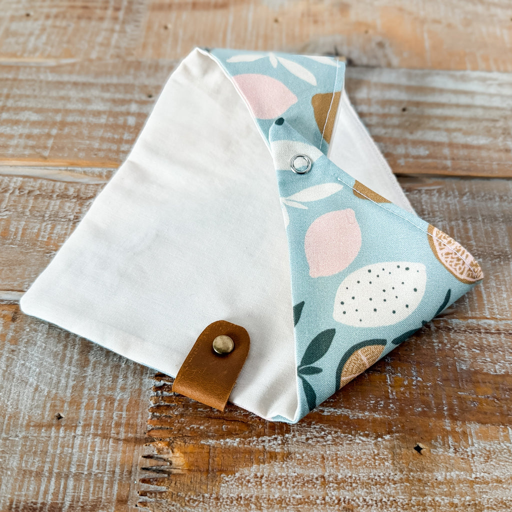Fabric pouch with floral design on a wooden surface