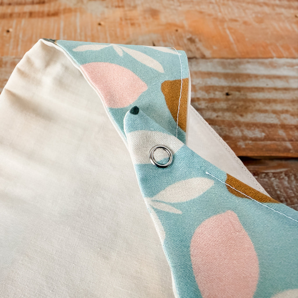 Fabric pouch with floral design on a wooden surface