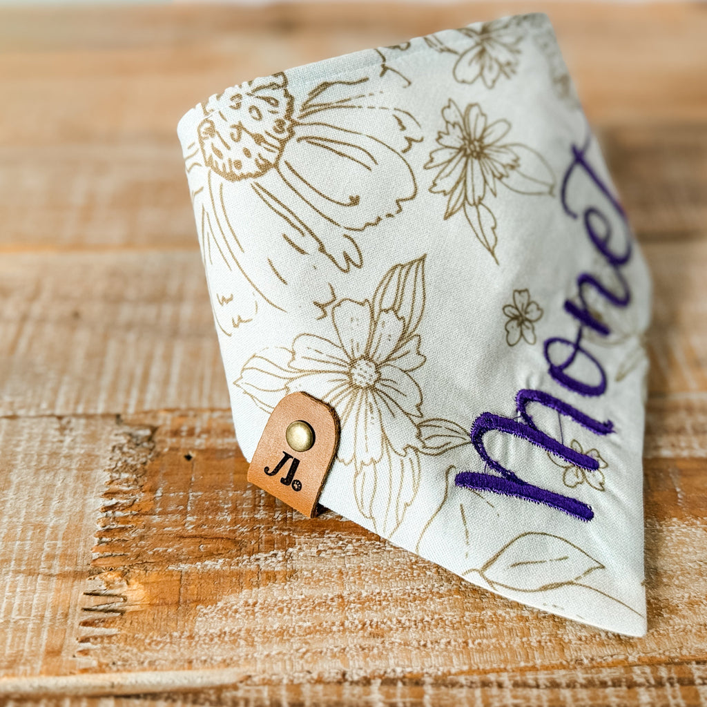 Floral-patterned money clip on a wooden surface