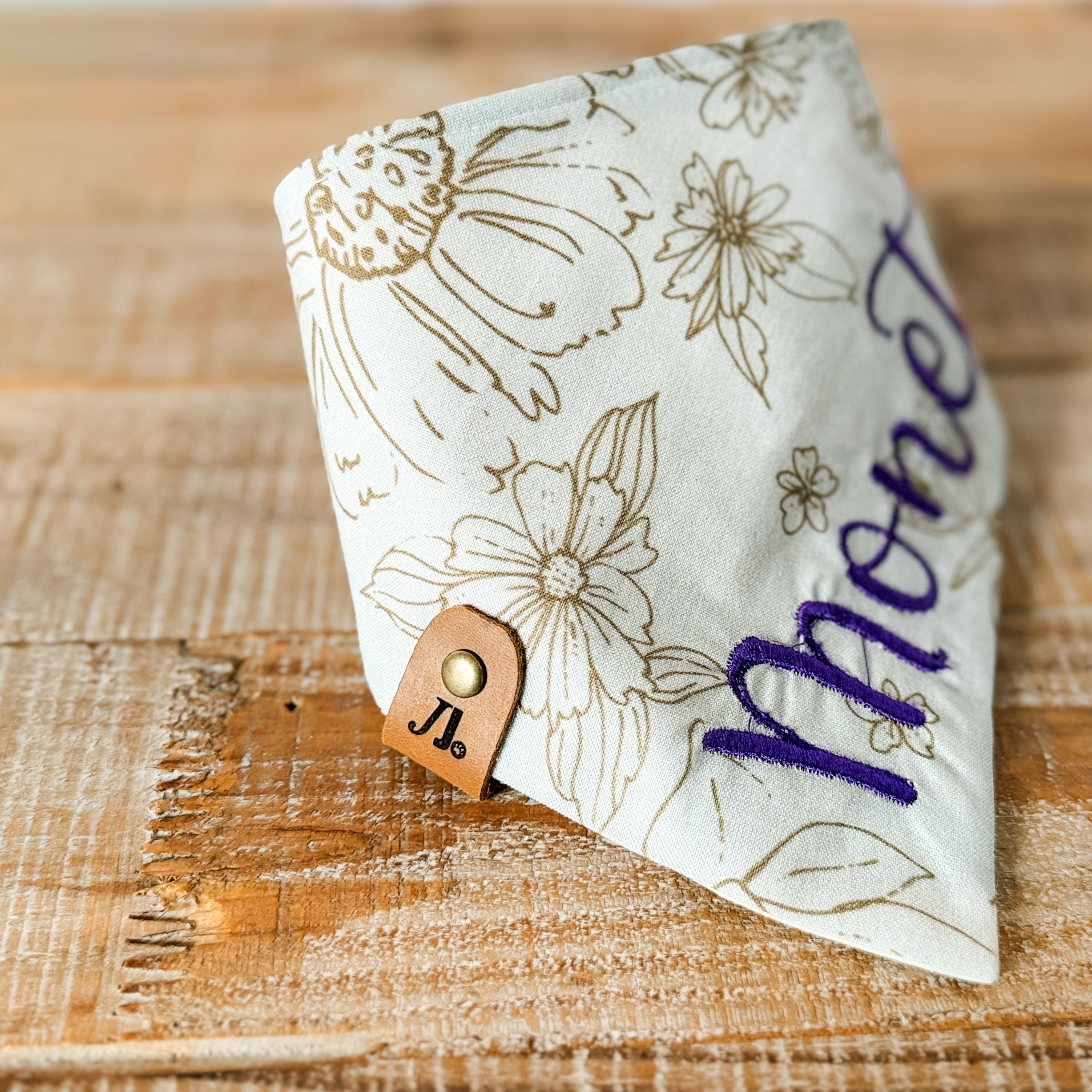 Floral-patterned money clip on a wooden surface