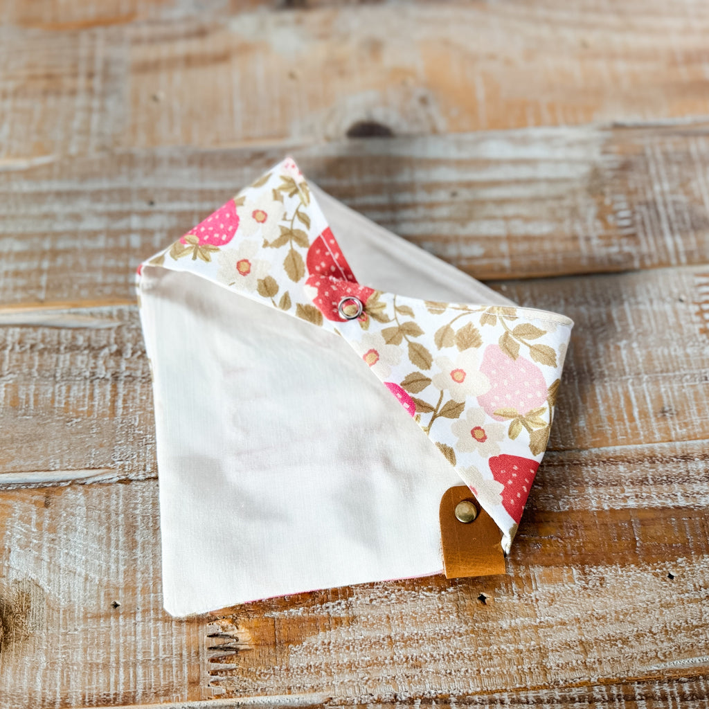 Floral patterned fabric triangle on a wooden surface