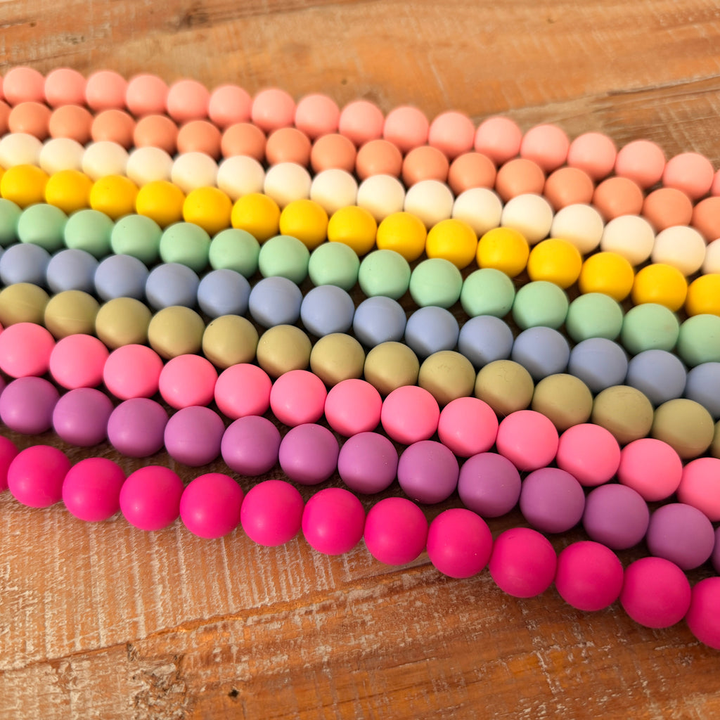 Colorful beaded bracelets arranged on a wooden surface