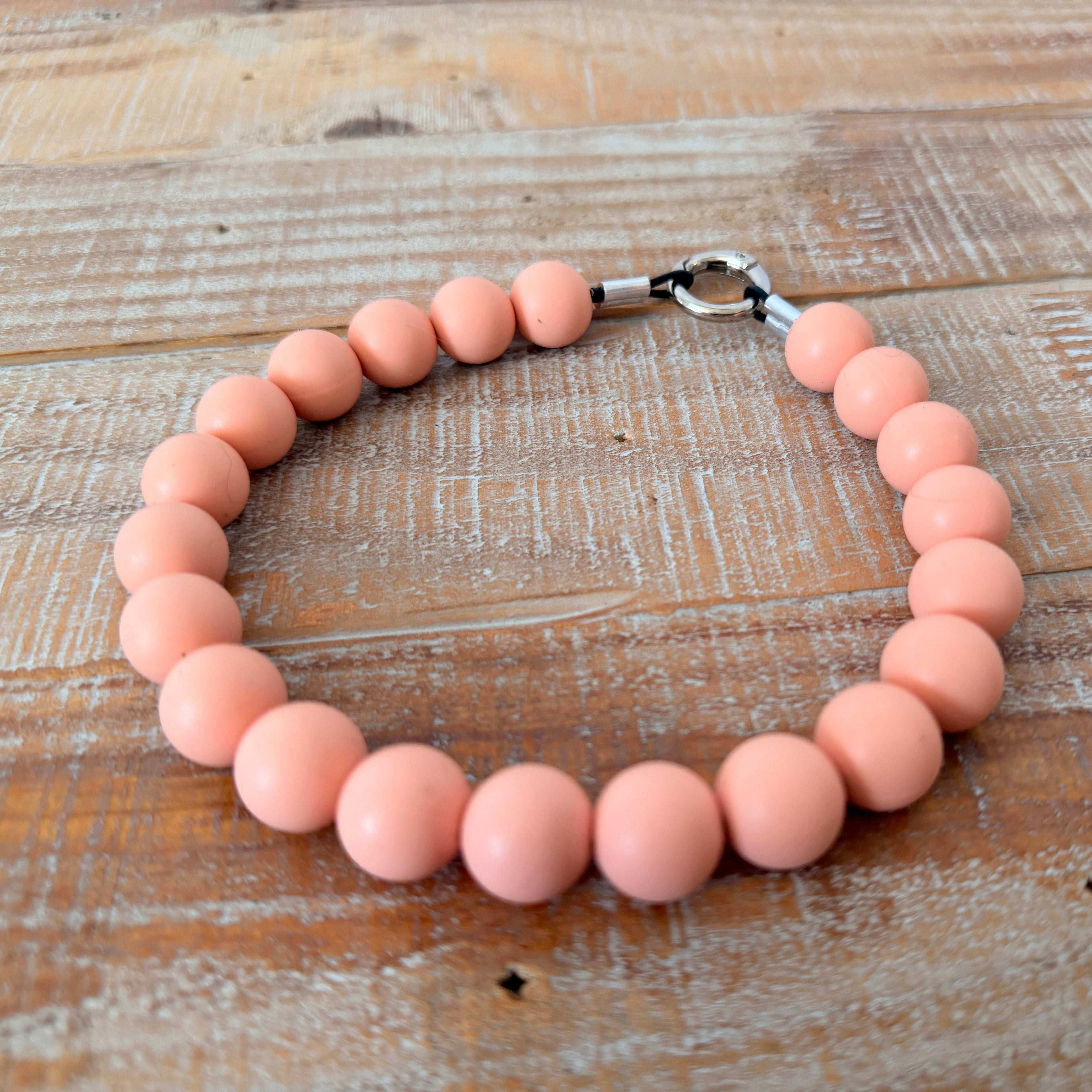 Pink beaded bracelet on a wooden surface