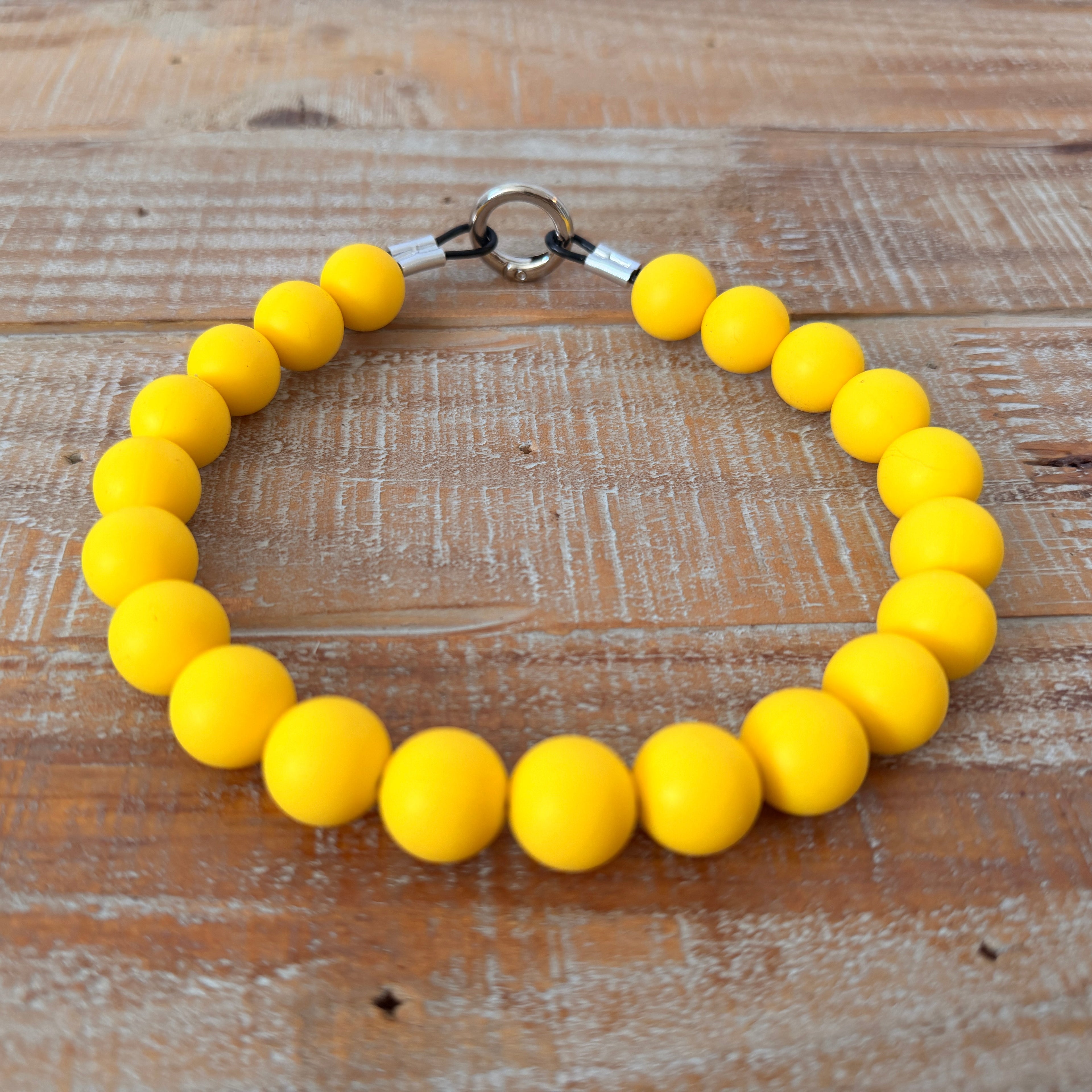 Yellow beaded bracelet on a wooden surface